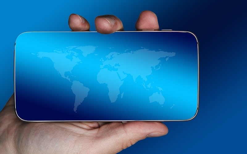 smartphone with world map in hand